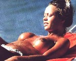 Anna Falchi nude in Topless sunbathing