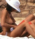 Cristina Parodi nude in topless sunbathing