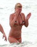Tara Reid in orange bikini