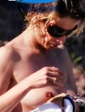 Isabella Ferrari nude in Topless sunbathing
