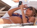 Rita Rusic nude in Topless sunbathing